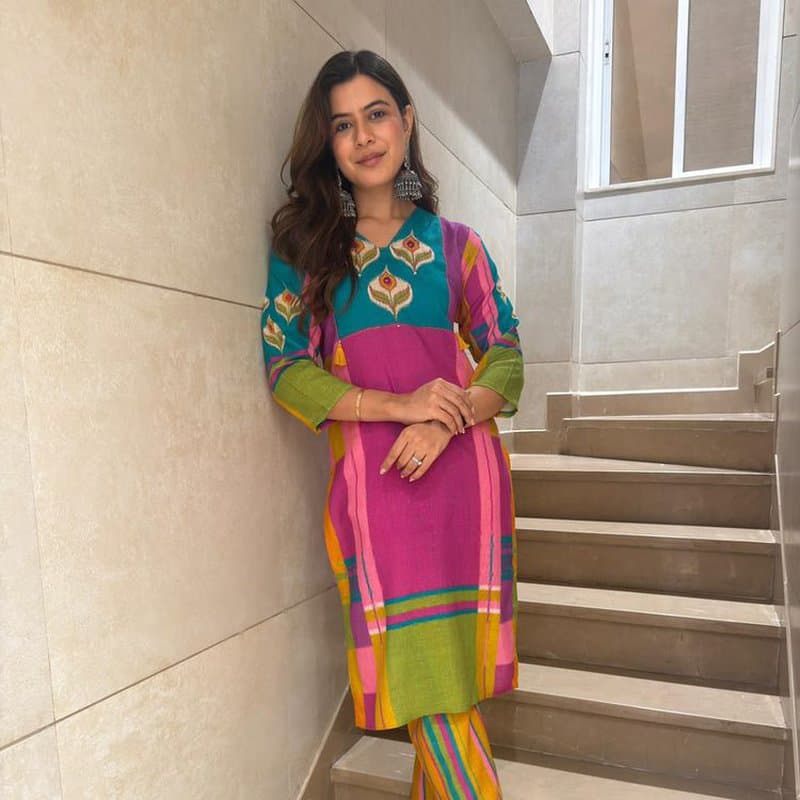 Ivory embroidered kurti styled with gold jewellery